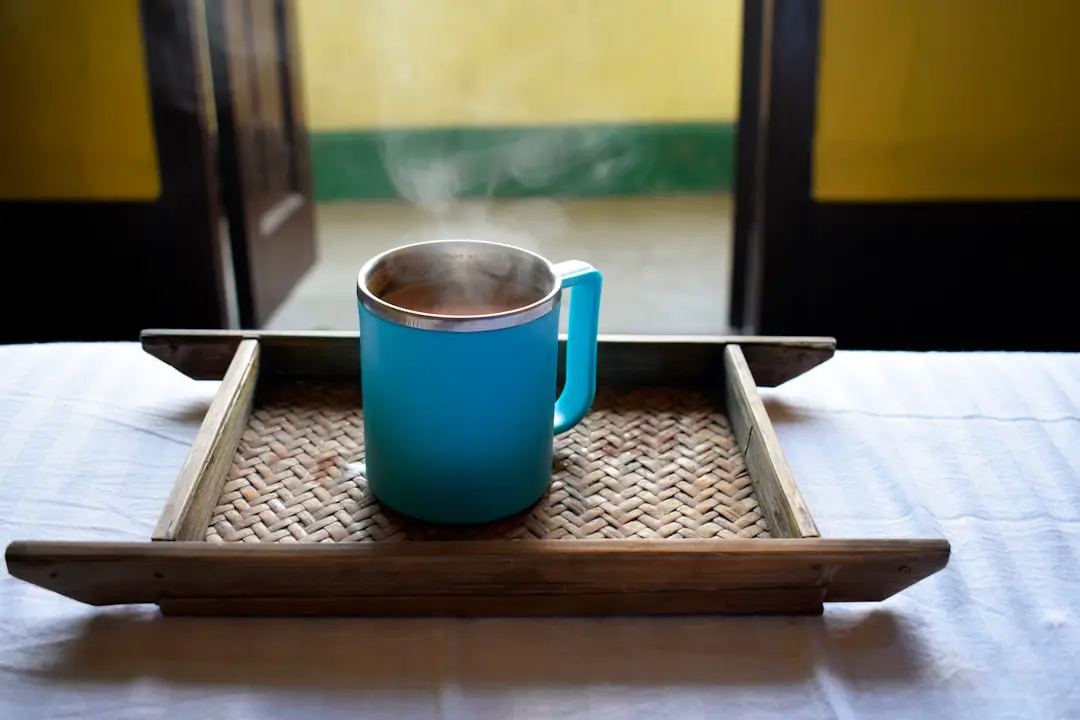 a blue cup on a wooden surface