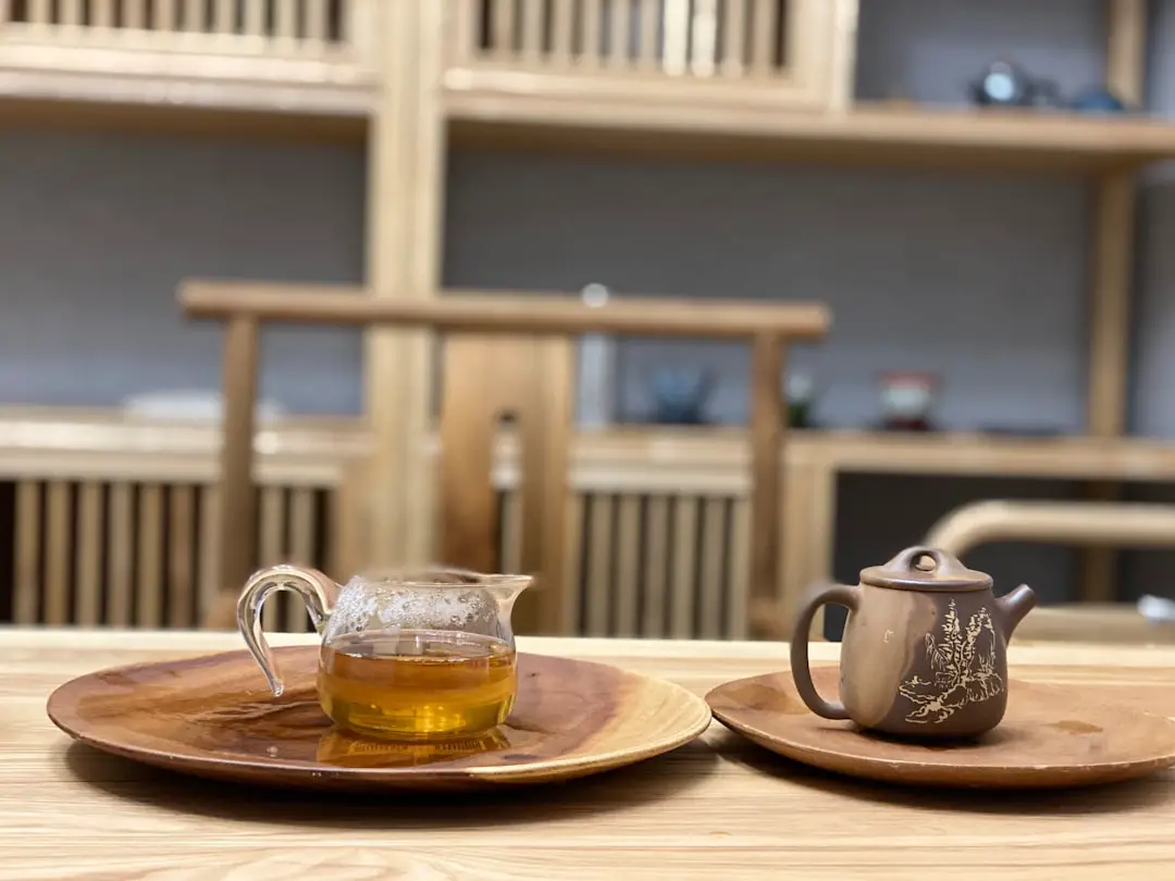 clear glass teapot on brown wooden tray