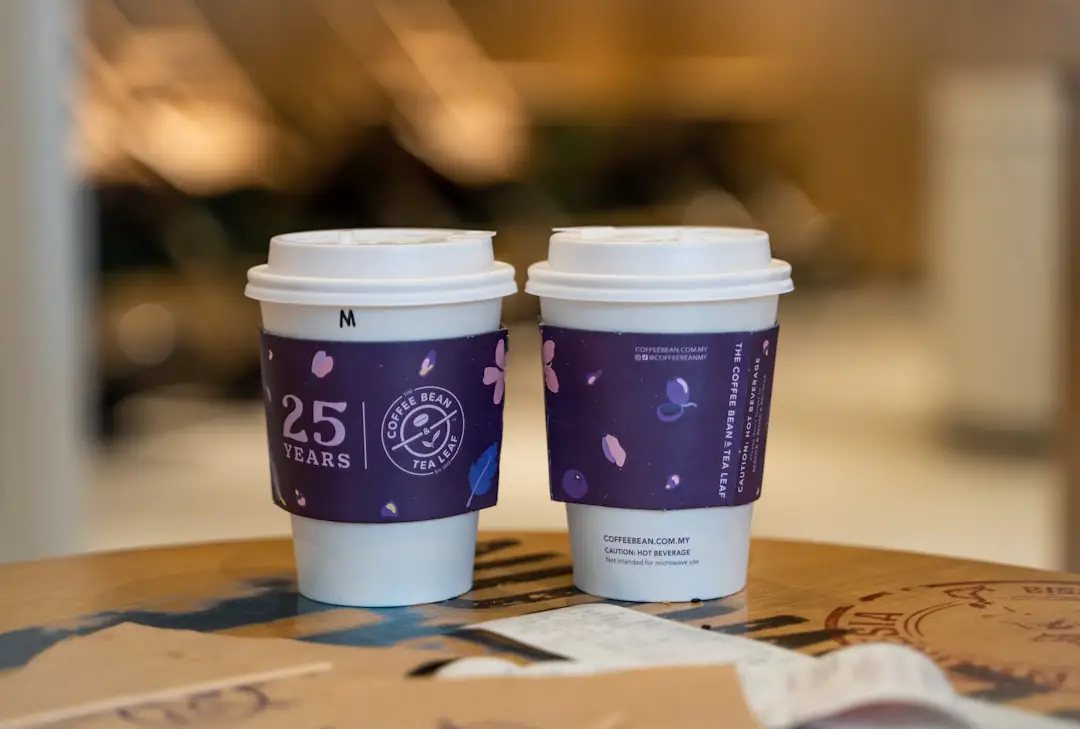 two cups of coffee sitting on top of a table