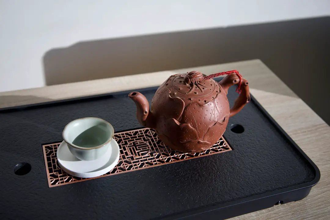 a tea pot and a cup on a tray